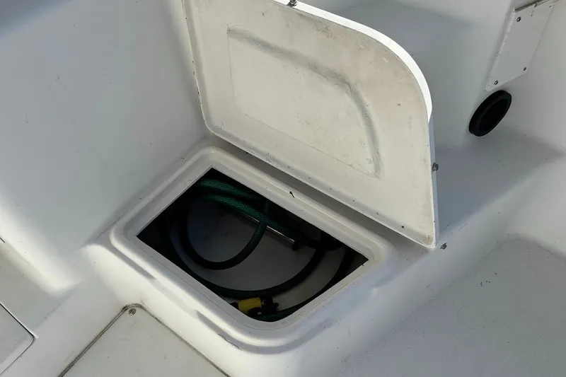 Slide: The Image of Open storage compartment on 2005 Seaswirl Striper 2301 Walkaround I/O boat. - 25