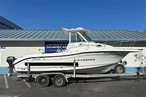 The Image of 2005 Seaswirl Striper 2301 Walkaround I/O boat on trailer, parked outdoors. - 0