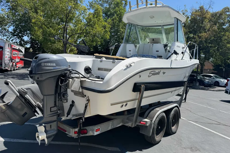 Slide: The Image of 2005 Seaswirl Striper 2301 Walkaround I/O boat on trailer, featuring Yamaha outboard motor. - 7