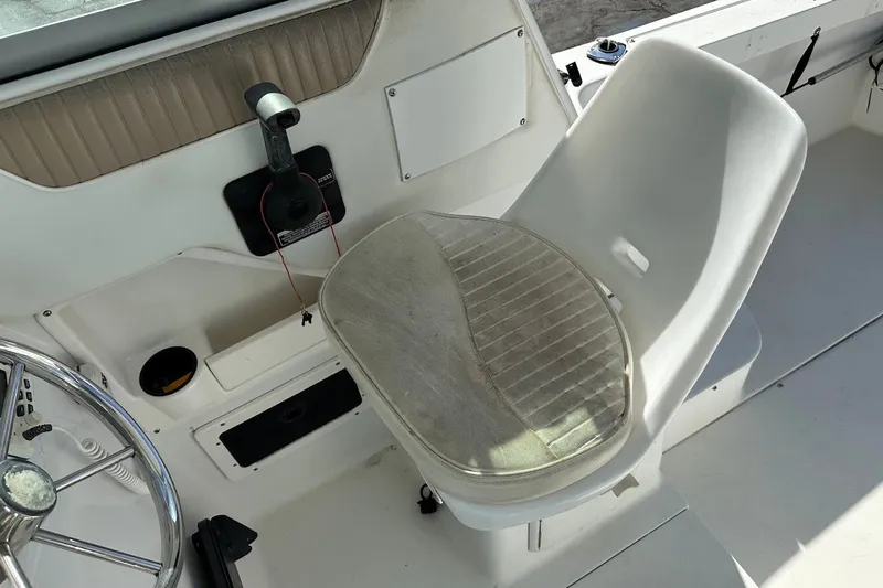 Slide: The Image of 2005 Seaswirl Striper 2301 Walkaround I/O boat interior with steering wheel and seat. - 17