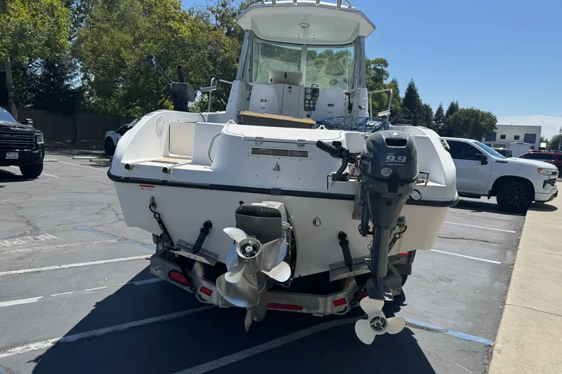 Slide: The Image of 2005 Seaswirl Striper 2301 Walkaround I/O boat in parking lot, rear view. - 8