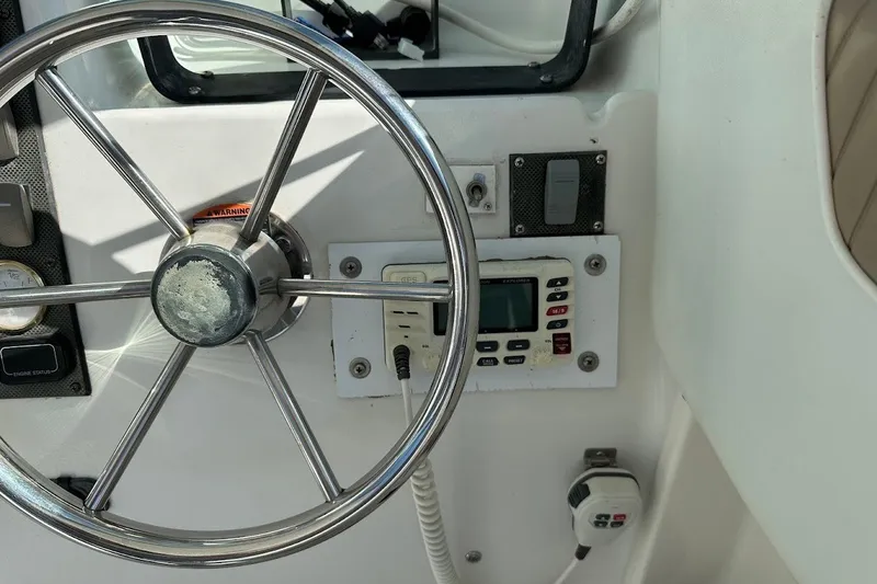 Slide: The Image of 2005 Seaswirl Striper 2301 Walkaround I/O helm with steering wheel and control panel. - 23