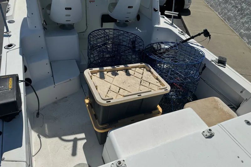 Slide: The Image of 2005 Seaswirl Striper 2301 Walkaround I/O boat interior with fishing gear and traps. - 9