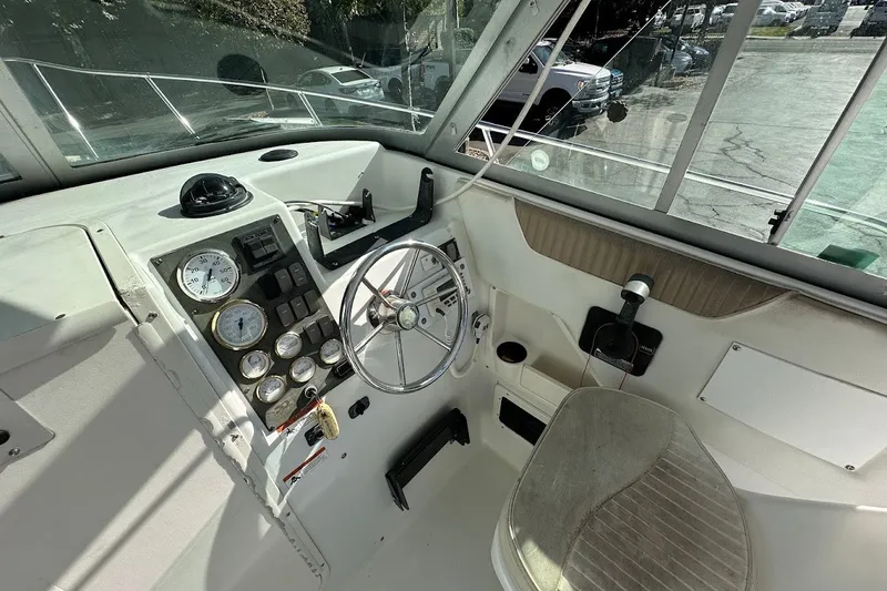 Slide: The Image of 2005 Seaswirl Striper 2301 Walkaround I/O boat cockpit with steering wheel and instrument panel. - 20