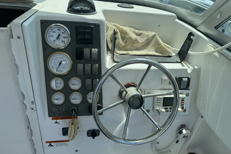 Slide: The Image of 2005 Seaswirl Striper 2301 Walkaround I/O dashboard with steering wheel and gauges. - 13