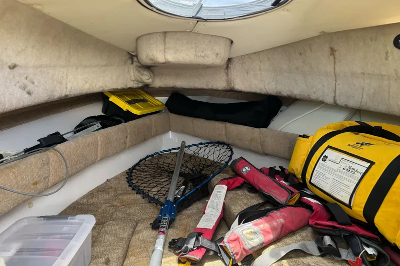 Slide: The Image of Interior of 2005 Seaswirl Striper 2301 Walkaround I/O with fishing gear and safety equipment. - 14