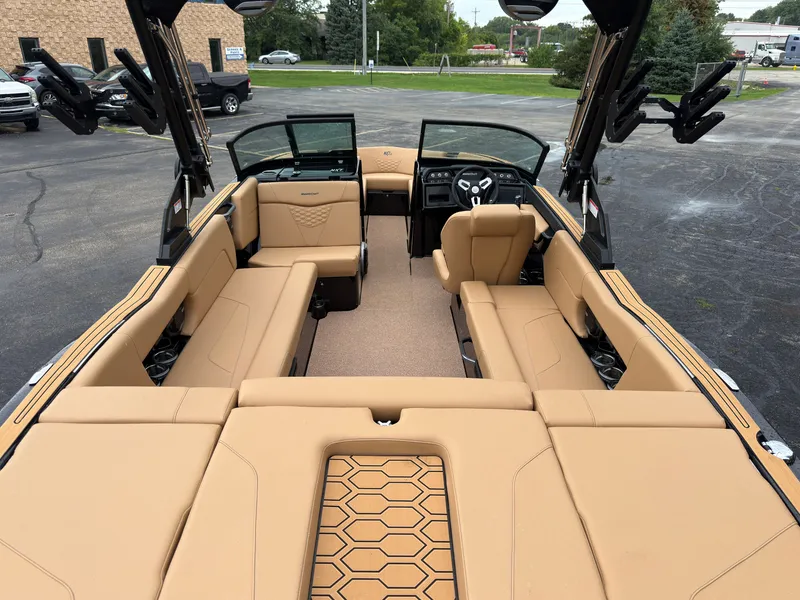 Slide: The Image of The image shows the interior of a 2027 MasterCraft NXT23 boat with beige seating. - 9