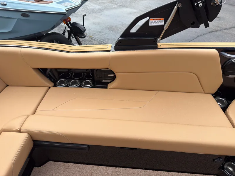 Slide: The Image of The image shows the beige upholstery of a 2027 MasterCraft NXT23 with cup holders. - 20