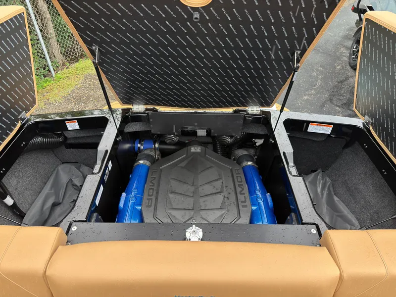 Slide: The Image of The engine compartment of a 2027 MasterCraft NXT23 features a powerful engine with blue accents. - 15