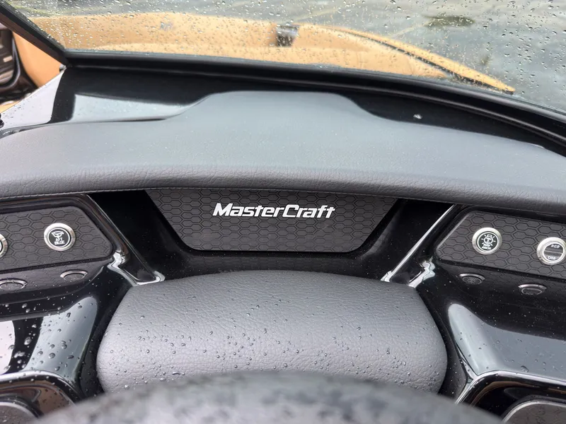 Slide: The Image of The dashboard of a MasterCraft NXT23 boat with modern controls and sleek design. - 33