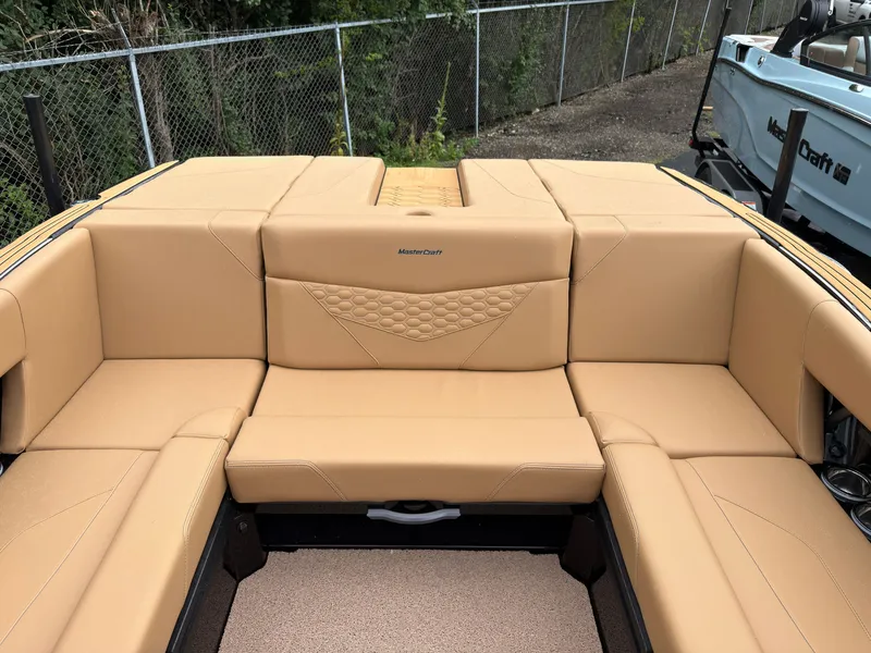 Slide: The Image of The image shows the interior of a MasterCraft NXT23 boat with beige upholstery and modern design. - 11