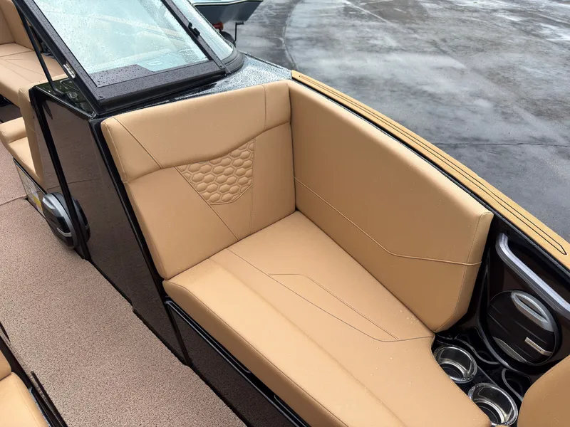 Slide: The Image of Beige seating in a modern boat with black accents and cup holders. - 48