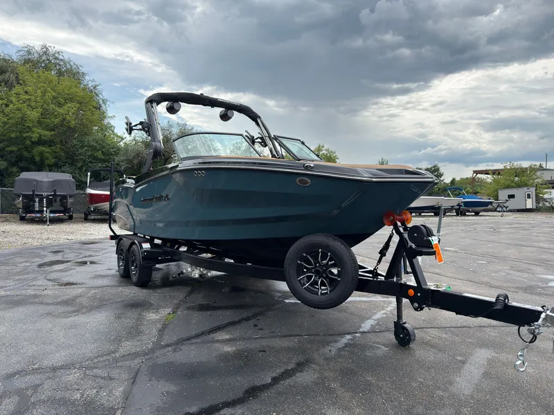 Slide: The Image of A 2027 MasterCraft NXT23 boat on a trailer, ready for transport. - 4