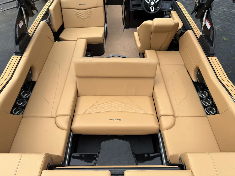Slide: The Image of The image shows the interior of a MasterCraft NXT23 boat with beige upholstery and multiple cup holders. - 24