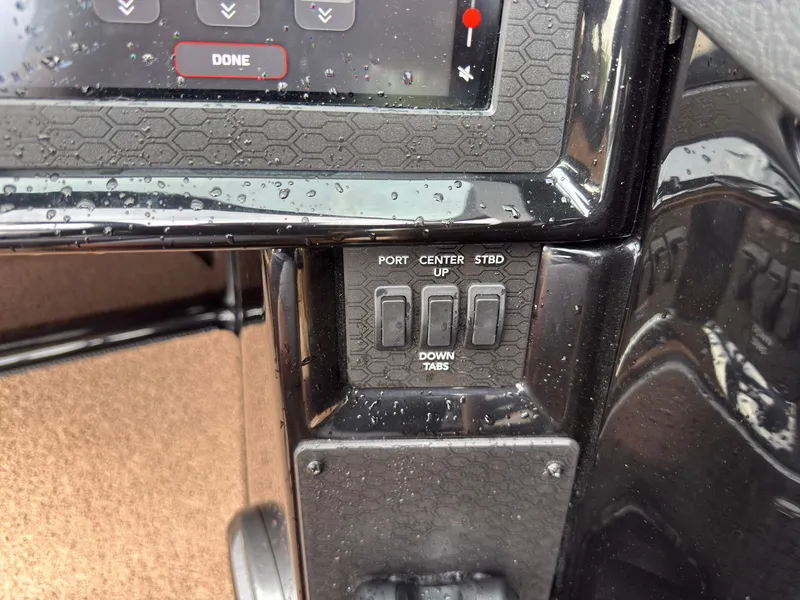 Slide: The Image of Close-up of a MasterCraft NXT23 boat's control panel with trim tab controls. - 40