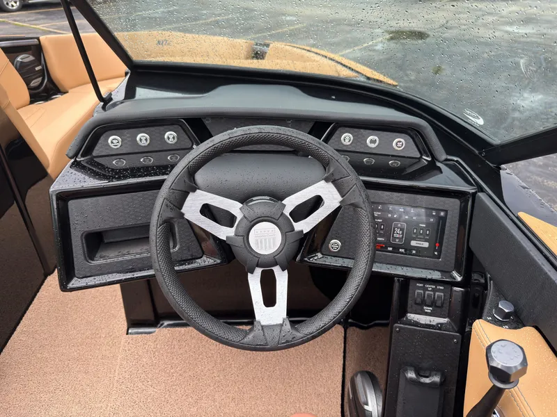 Slide: The Image of The image shows the cockpit of a MasterCraft NXT23 boat with a modern steering wheel and dashboard. - 31