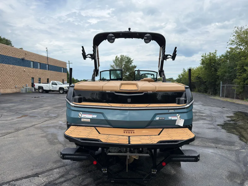 Slide: The Image of A 2027 MasterCraft NXT23 is parked on a lot. The boat features a modern design. - 7