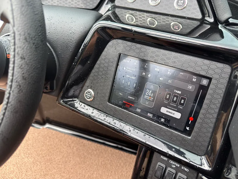 Slide: The Image of The image shows the dashboard of a MasterCraft NXT23 boat with a modern touchscreen display. - 36