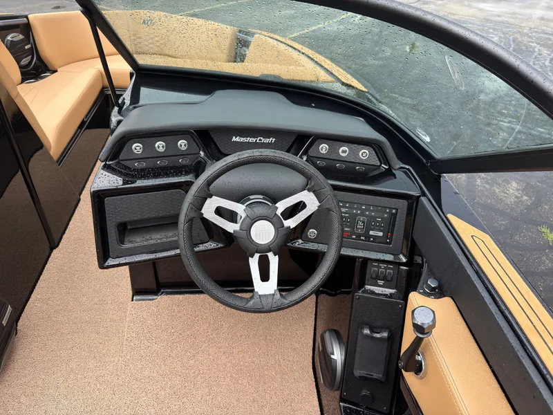 Slide: The Image of The image shows the cockpit of a MasterCraft NXT23 boat. It features a modern steering wheel and digital dashboard. - 30