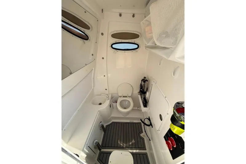Slide: The Image of 2024 Sea Hunt Gamefish 30CB boat interior with toilet, sink, and storage compartments. - 21