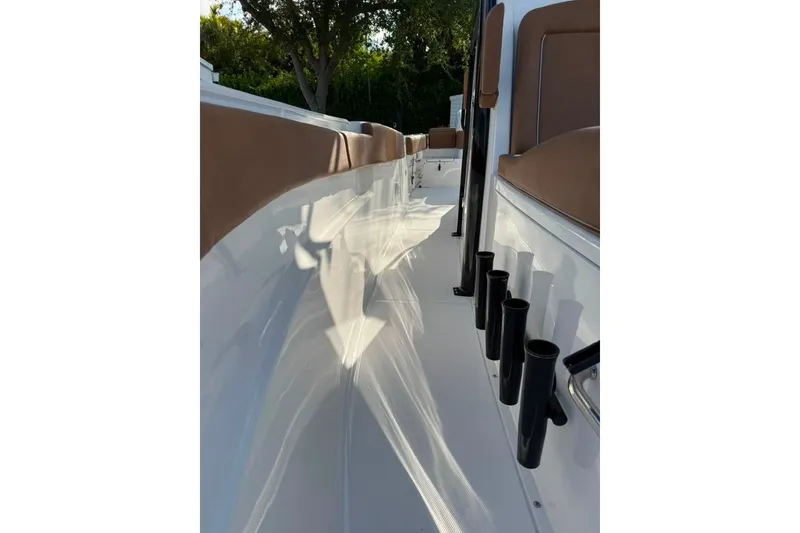 Slide: The Image of 2024 Sea Hunt Gamefish 30CB boat interior with rod holders and cushioned seating. - 22