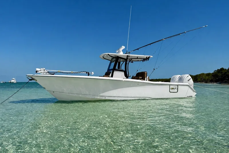 The Image of 2024 Sea Hunt Gamefish 30CB boat anchored in clear turquoise water. - 0