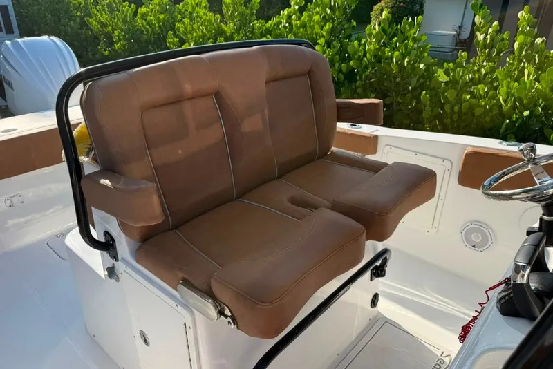 Slide: The Image of 2024 Sea Hunt Gamefish 30CB boat with brown cushioned seating and steering wheel. - 19