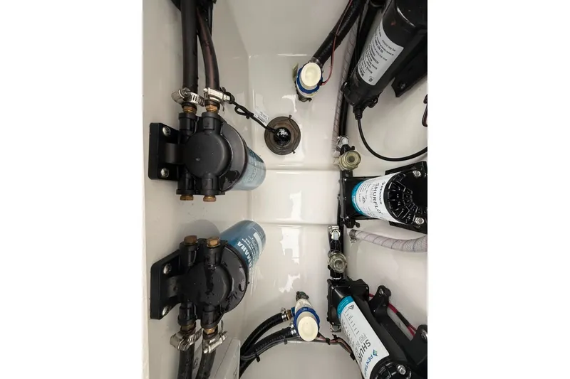 Slide: The Image of 2024 Sea Hunt Gamefish 30CB boat plumbing system with pumps and hoses. - 24