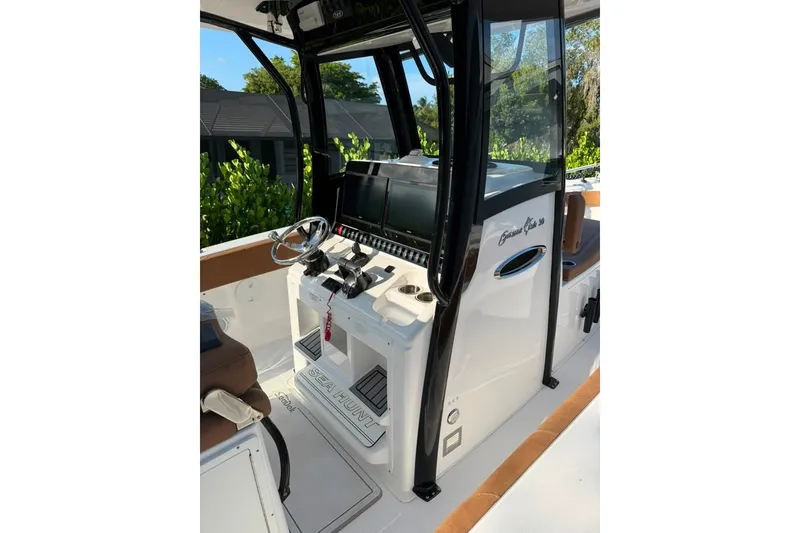 Slide: The Image of 2024 Sea Hunt Gamefish 30CB helm with modern controls and sleek design. - 13