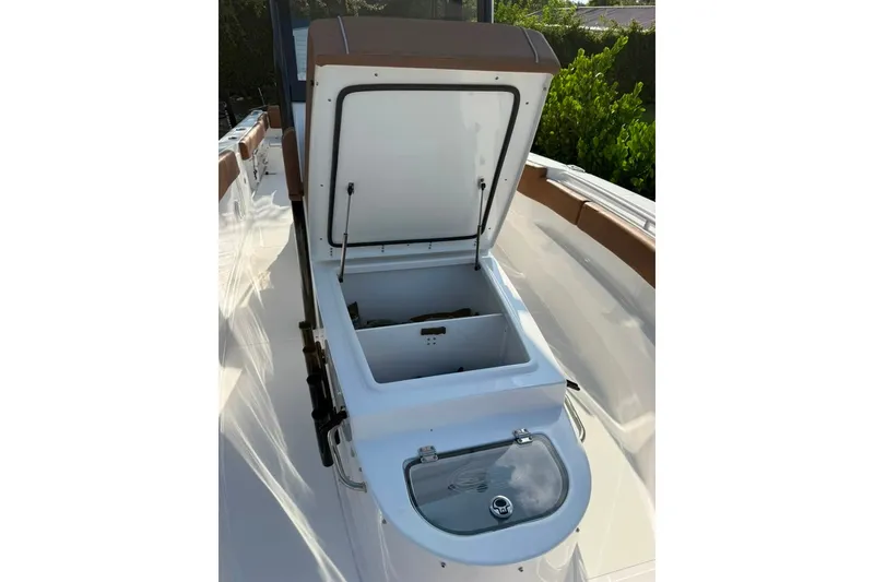 Slide: The Image of 2024 Sea Hunt Gamefish 30CB boat with open storage compartment on deck. - 18