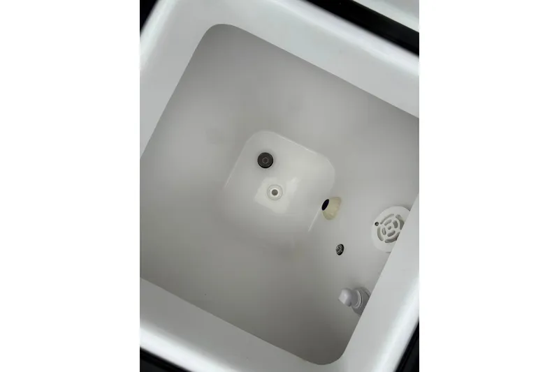 Slide: The Image of Livewell interior of 2024 Sea Hunt Gamefish 30CB boat, featuring drainage and aeration systems. - 20