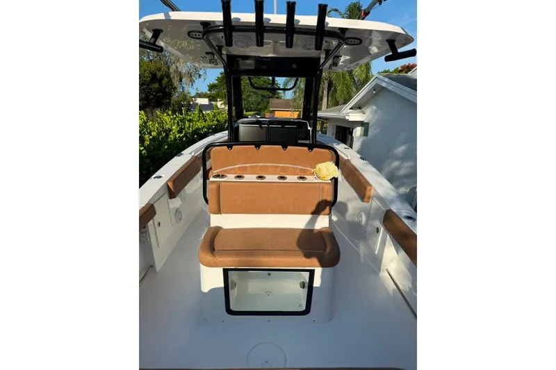 Slide: The Image of 2024 Sea Hunt Gamefish 30CB boat interior with tan seating and rod holders. - 15
