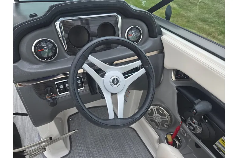 Slide: The Image of 2017 Chaparral 246 SSi boat dashboard with steering wheel and control panel. - 14