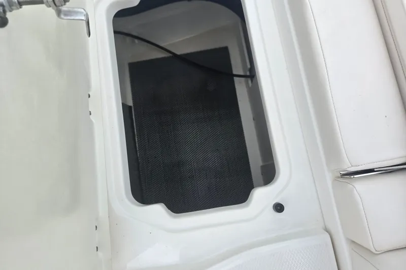 Slide: The Image of Storage compartment on a 2017 Chaparral 246 SSi boat, featuring white interior design. - 27