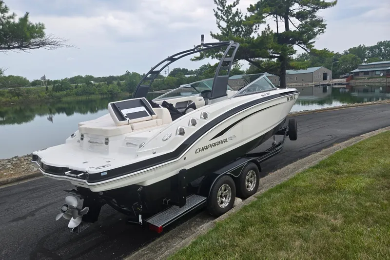 Slide: The Image of 2017 Chaparral 246 SSi boat on trailer by a scenic lakeside road. - 1