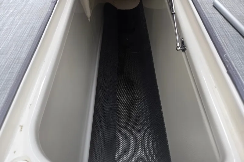 Slide: The Image of Storage compartment of a 2017 Chaparral 246 SSi boat, featuring a sleek interior design. - 12
