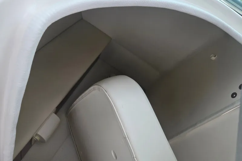 Slide: The Image of Interior cabin of 2017 Chaparral 246 SSi boat, featuring cushioned seating. - 17