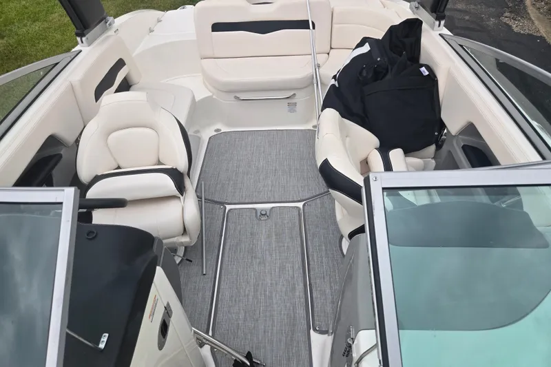 Slide: The Image of 2017 Chaparral 246 SSi boat interior with white seating and gray flooring. - 22