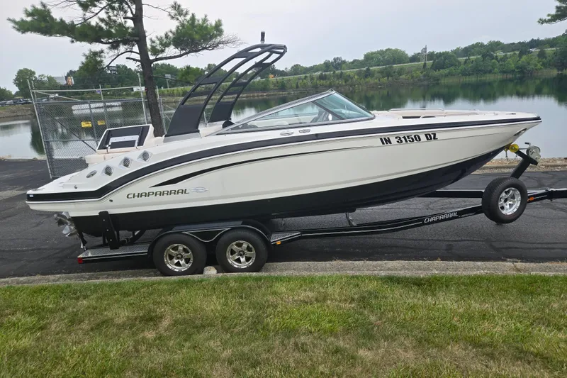 Slide: The Image of 2017 Chaparral 246 SSi boat on trailer by a lakeside, ready for transport. - 9
