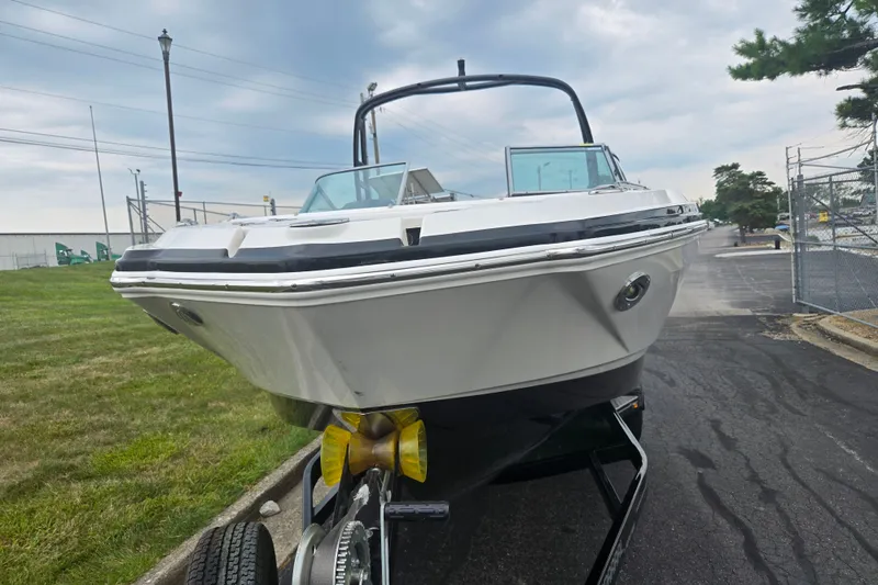 Slide: The Image of 2017 Chaparral 246 SSi boat on trailer, parked outdoors on a cloudy day. - 6