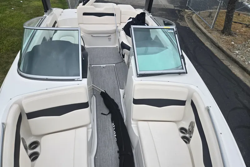 Slide: The Image of 2017 Chaparral 246 SSi boat interior with white seating and open windshield. - 21