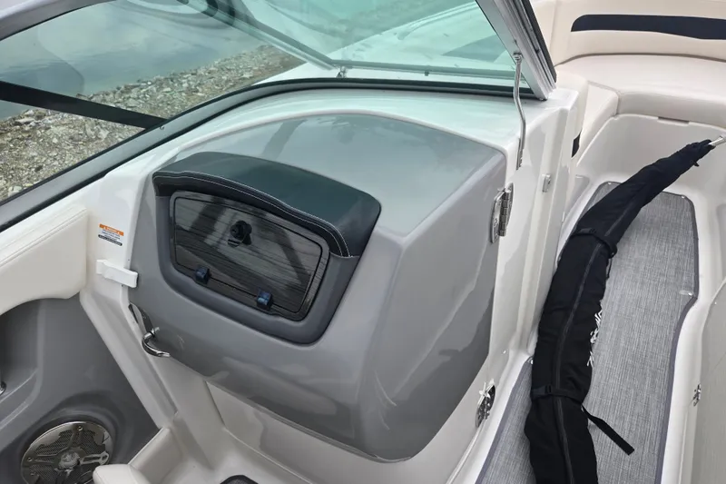 Slide: The Image of 2017 Chaparral 246 SSi boat interior with storage compartment and seating area. - 16