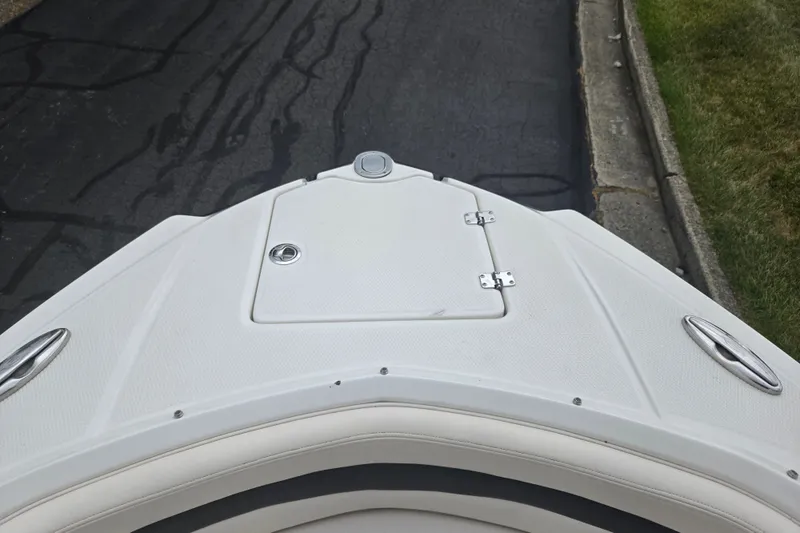 Slide: The Image of Bow view of 2017 Chaparral 246 SSi boat, featuring sleek white deck design. - 19