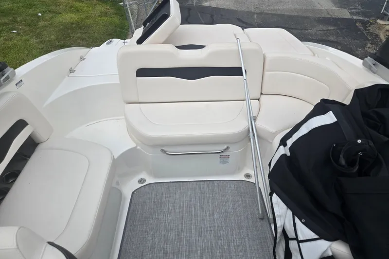 Slide: The Image of 2017 Chaparral 246 SSi boat interior with white seating and a gray floor mat. - 23