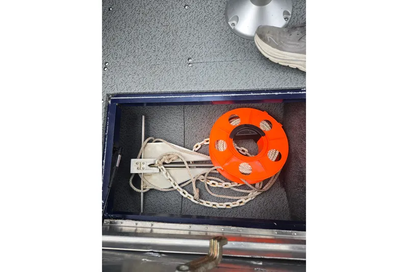 Slide: The Image of 2019 Tracker Targa V-18 Combo boat storage with anchor and orange rope reel. - 18