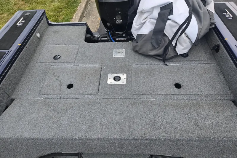 Slide: The Image of 2019 Tracker Targa V-18 Combo boat deck with storage compartments and motor. - 25