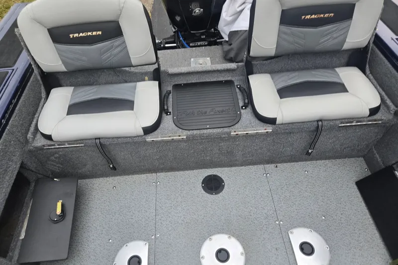Slide: The Image of 2019 Tracker Targa V-18 Combo boat interior with dual seats and storage compartments. - 24