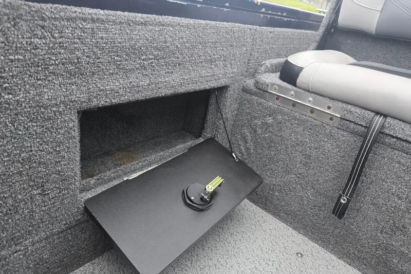 Slide: The Image of Interior of 2019 Tracker Targa V-18 Combo boat showing storage compartment and seat detail. - 14