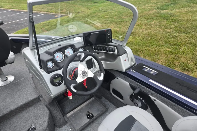Slide: The Image of 2019 Tracker Targa V-18 Combo boat cockpit with steering wheel and instrument panel. - 13