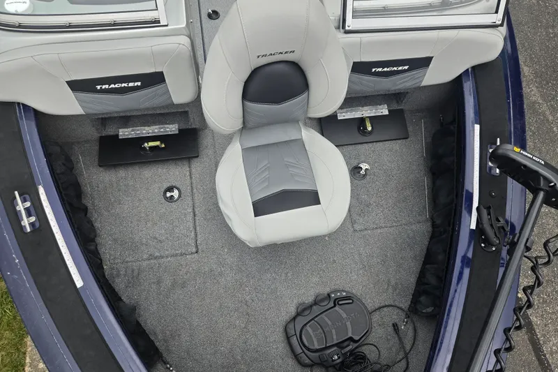 Slide: The Image of 2019 Tracker Targa V-18 Combo boat interior with gray seating and fishing equipment. - 21